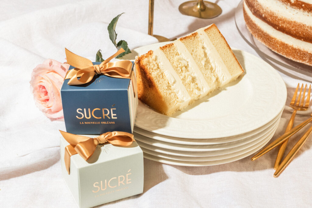 Sucre gift boxes with a slice of cake